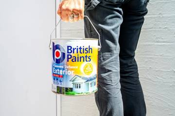 A person holding a bucket of paint

AI-generated content may be incorrect.